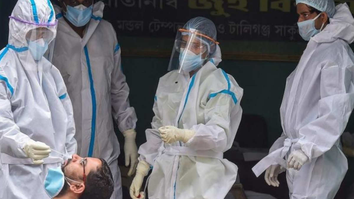 Health workers collecting swab sample of a person for COVID-19 test 