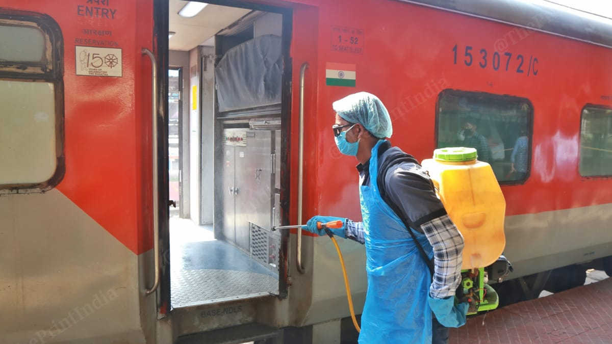 Train coaches being sanitized by the worker.